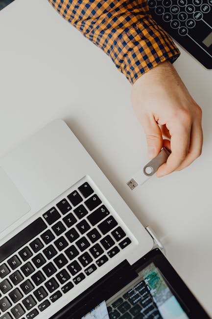 Person reviewing laptop specs on a screen with a checklist