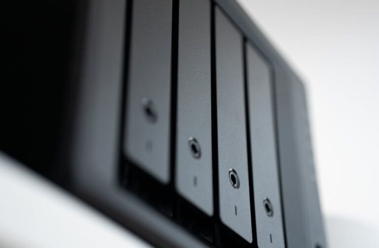 Choosing a NAS for Media and Backups: RAID Levels, Storage Planning, and Security Essentials shown on a desk setup