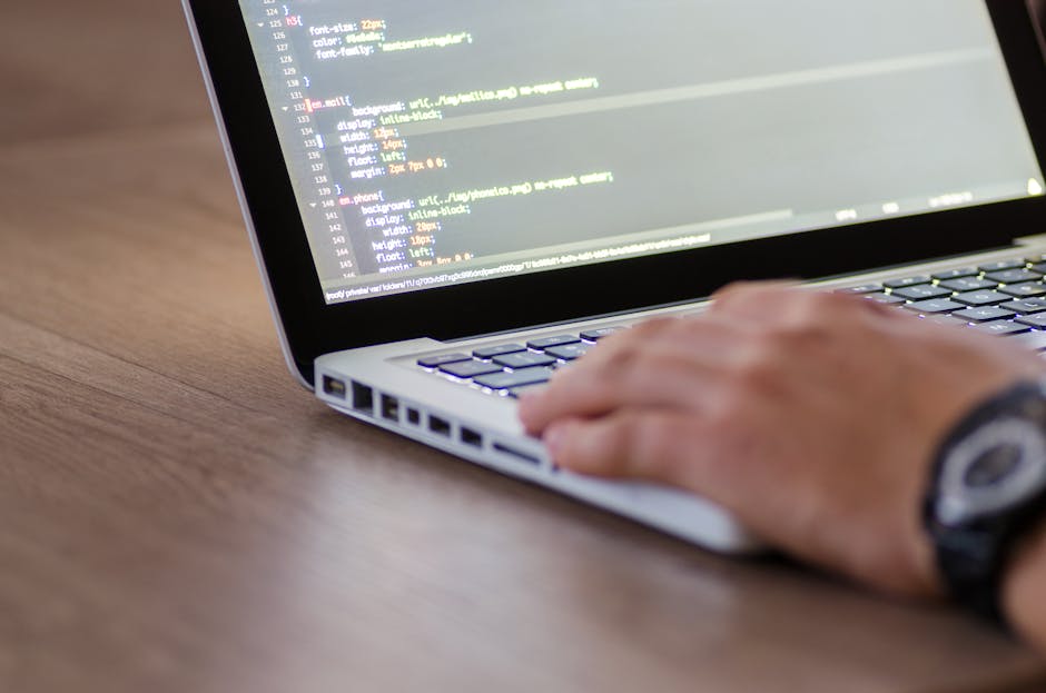 Developer working on a laptop with IDE windows and container logs on screen