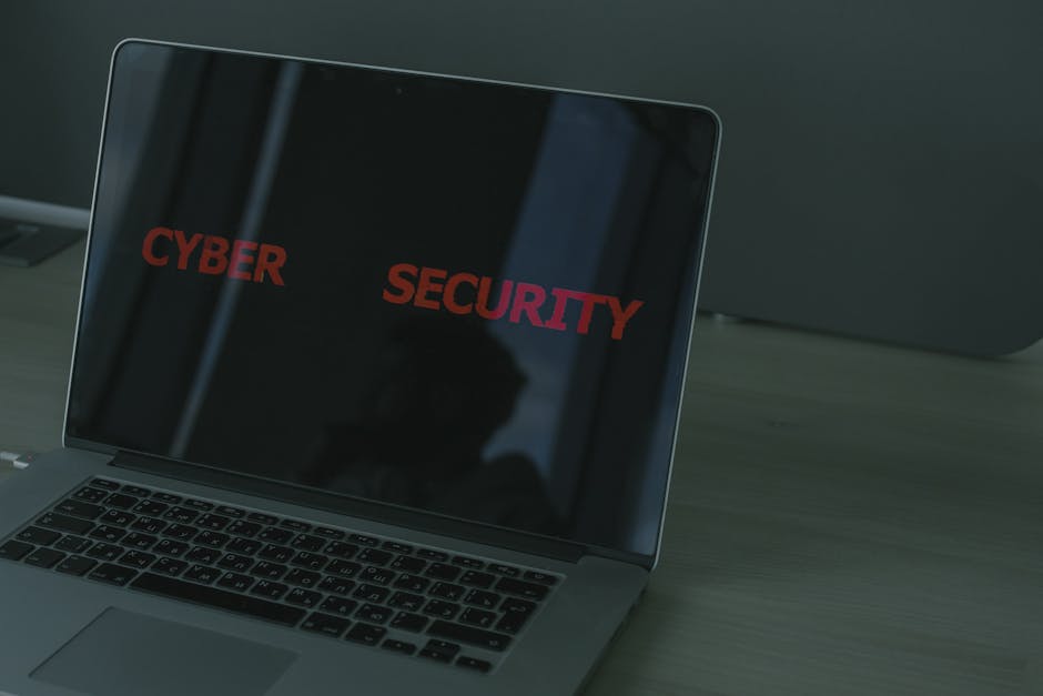 Close-up of a laptop screen with security icons and a person checking privacy settings