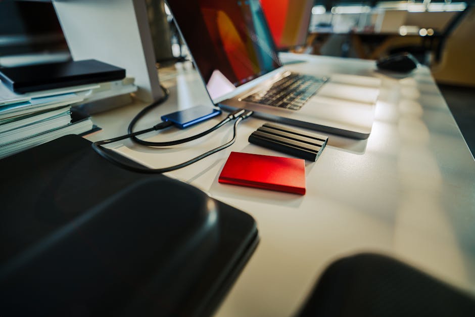 External NVMe drive enclosure connected to a laptop on a desk with visible airflow