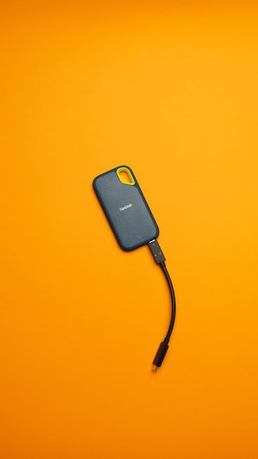 External SSD connected to a laptop with backup files ready for safer storage