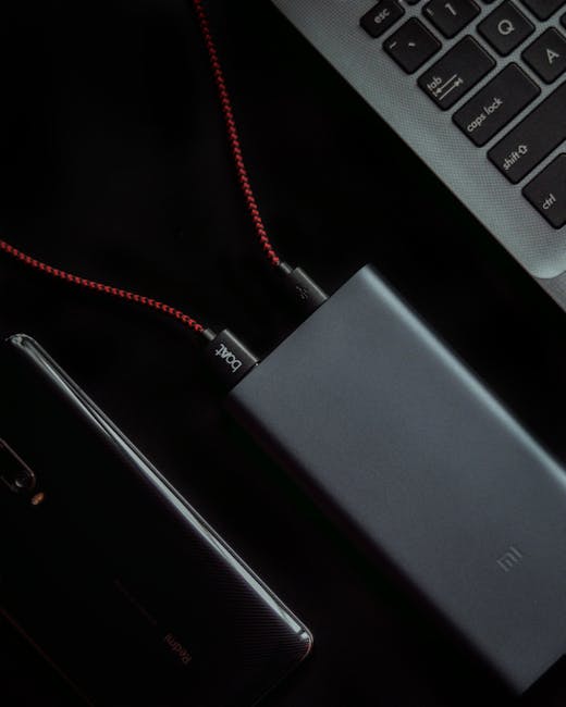 Laptop connected to a USB-C dock charging on a desk