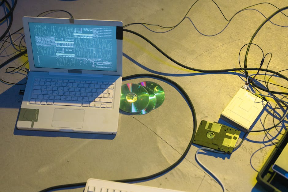 Person viewing transfer speeds on a laptop while copying data to an external NVMe drive