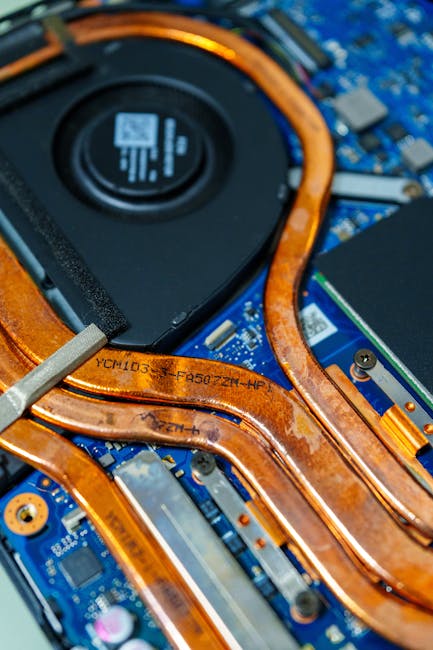 Close-up of a laptop cooling fan and heat vents indicating thermal throttling risk