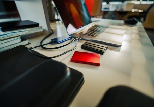 Laptop SSD vs External NVMe comparison showing fast storage and portable setup in a clean workspace.
