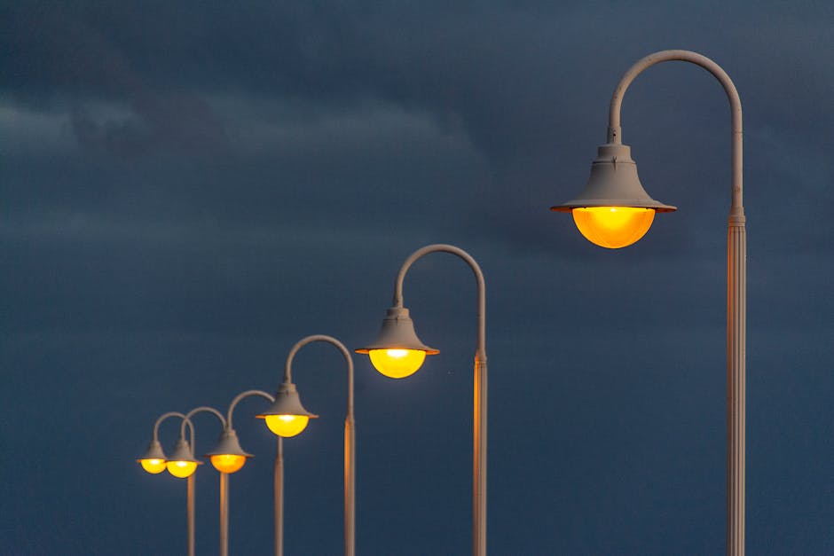 Phone photographing street lamps at night to compare lens results