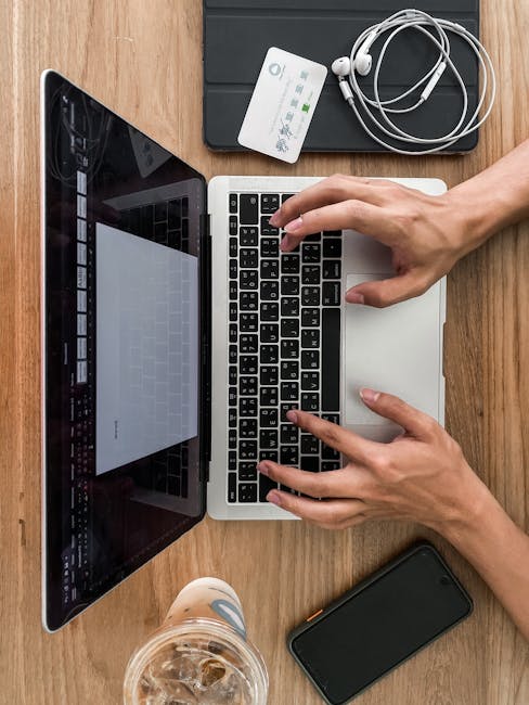 Person using a laptop near a home Wi‑Fi router, connected for improved streaming and calls