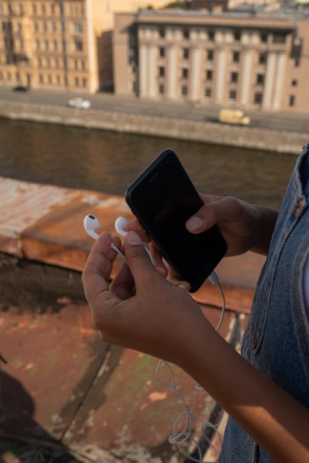 Close-up of a person wearing wired earbuds with a microphone for clear calls