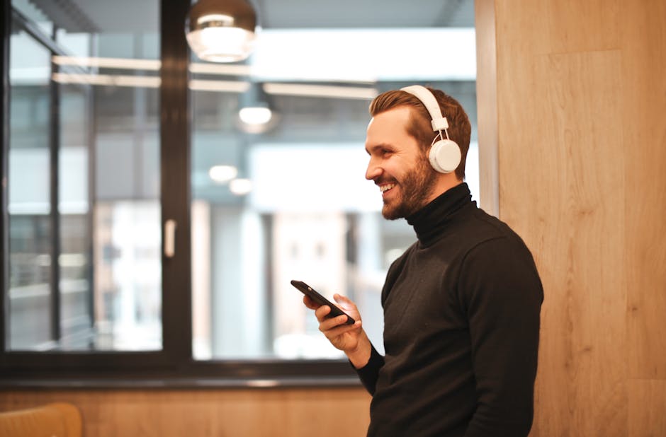 Person using a phone with Bluetooth headphones showing audio connection