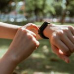 Smartphone displaying smartwatch vs fitness tracker comparison, illustrating smart health data and goals