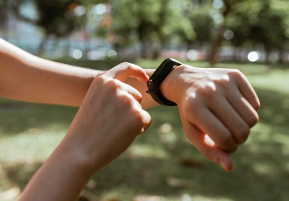 Smartphone displaying smartwatch vs fitness tracker comparison, illustrating smart health data and goals