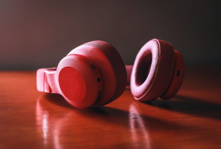 Person using headphones at a desk and on the go, comparing Wireless vs. Wired for work and travel reliability.