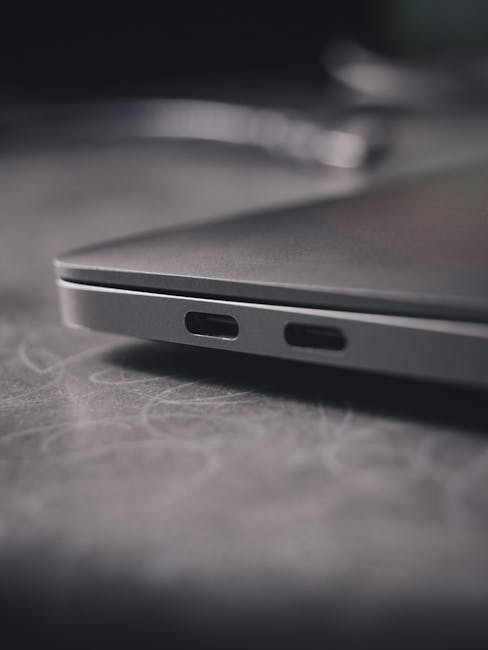 Laptop connected to a USB-C power cable while charging on a desk