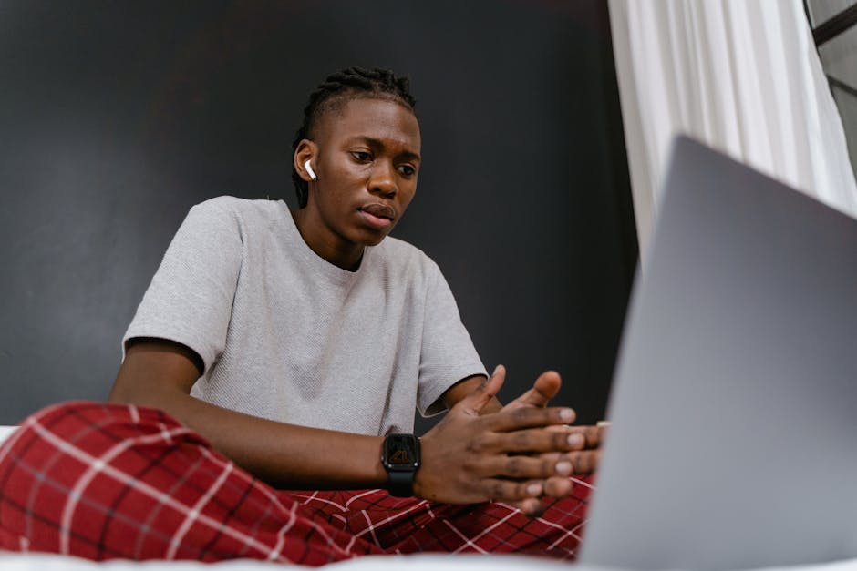 Close-up of a person watching a video with Bluetooth headphones showing audio delay symptoms