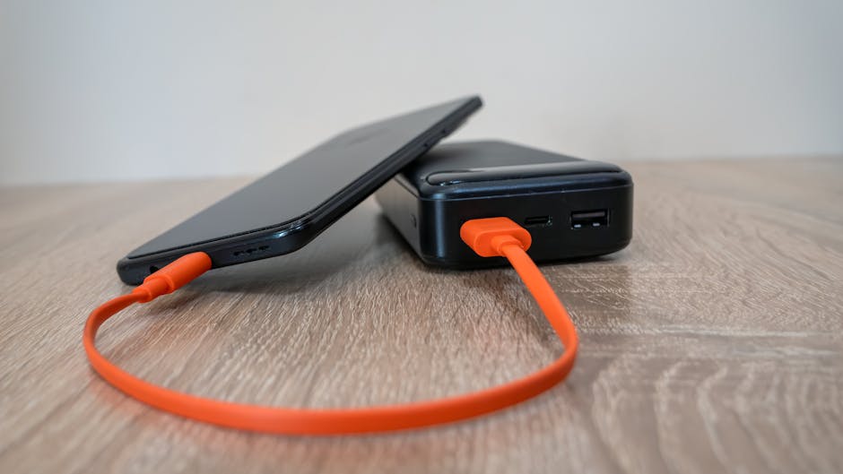Compact power bank charging a smartphone on a table