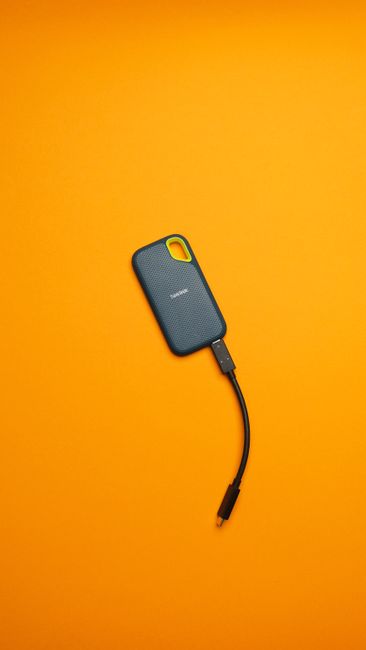 Review: The Most Reliable Portable SSDs for Travel—speed tests and durability on a portable SSD at a desk (Pexels)