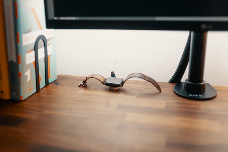 Smartwatch charging beside a bed at night, highlighting battery impact on sleep tracking.