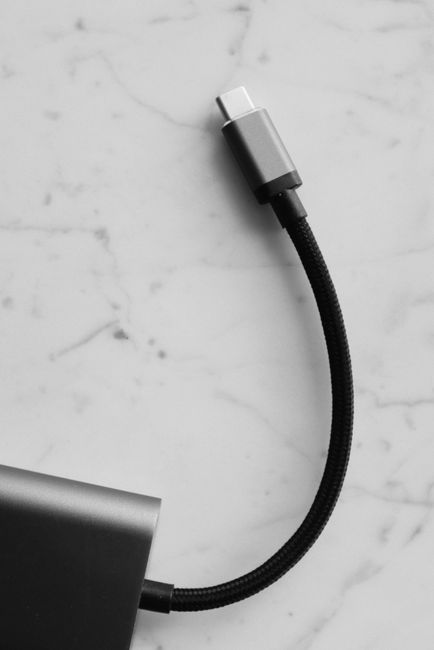 USB-C cable connected to a laptop and dock, showing power plus data/video capability